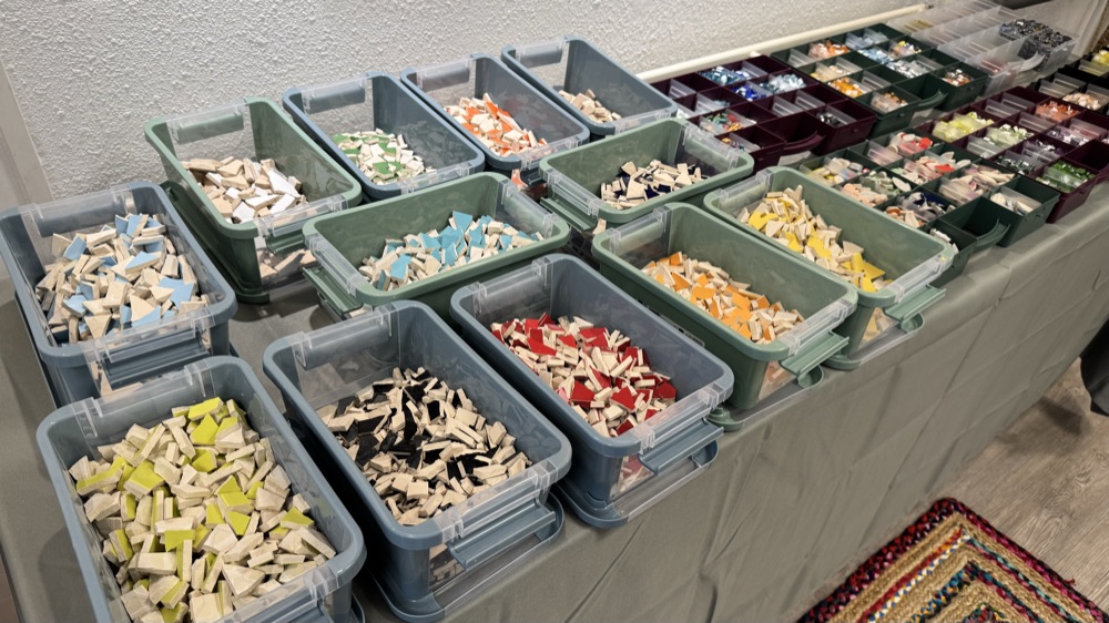 Mozaïeksteentjes op kleur gesorteerd op de materialentafel